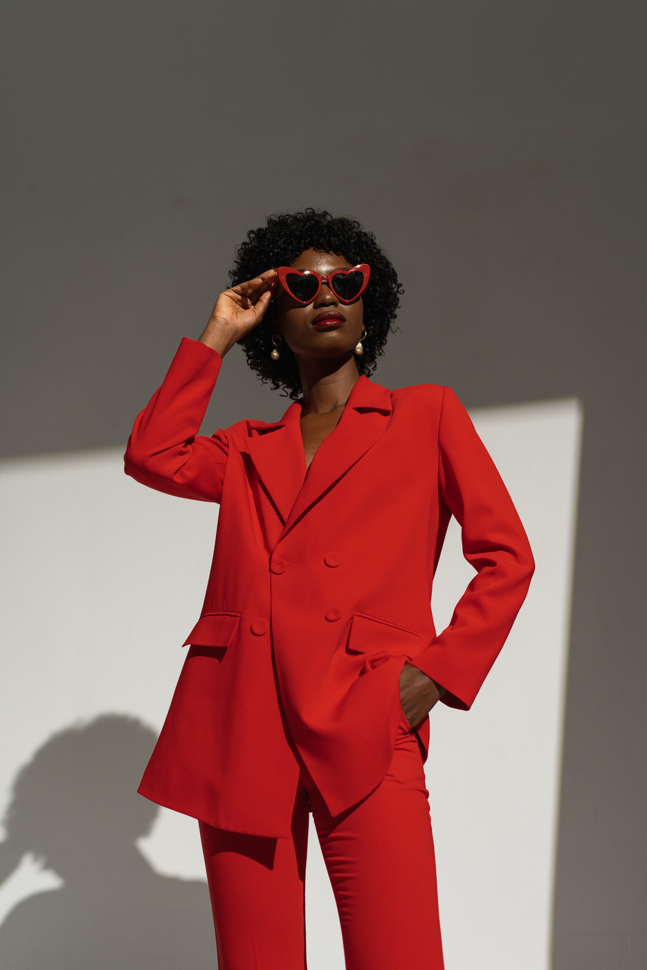 Fashionable Woman in Red Sunglasses and Suit
